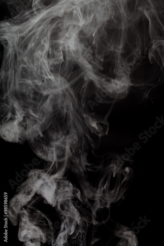 Fototapeta Naklejka Na Ścianę i Meble -  Abstract Smoke from electronic cigarette over a black color background