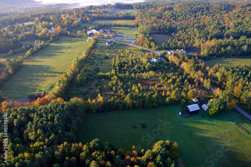 An aerial view of a hot air balloon floating over the Vermont country side ..