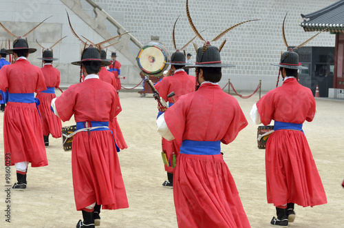 Row of armed guards in ancient traditional soldier uniforms in the old royal residence, Seoul, South Korea.. photo