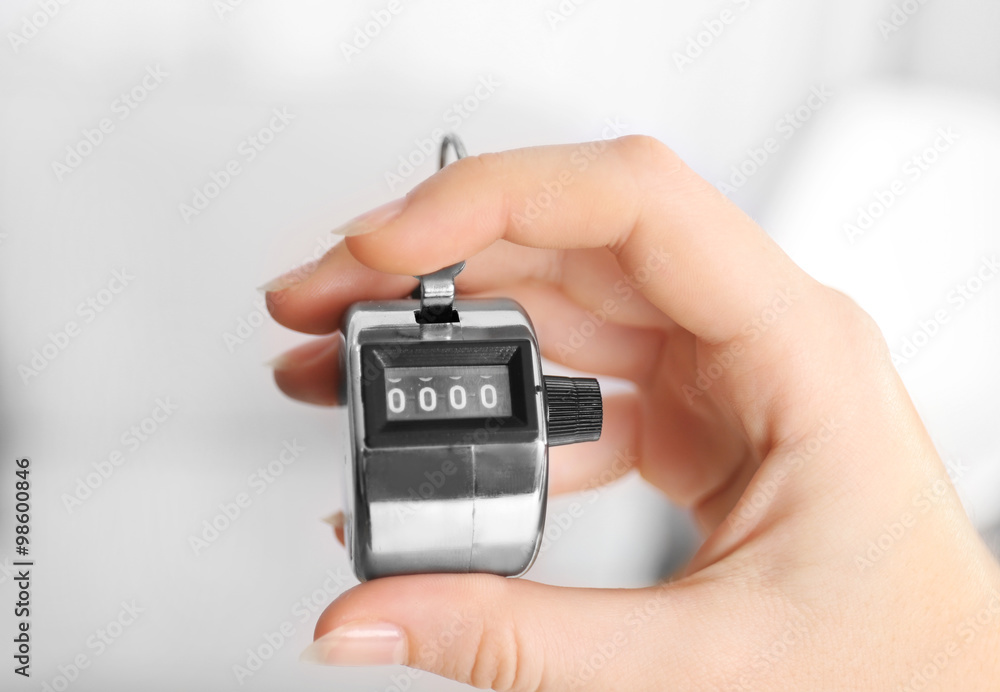 Stopwatch in hand on blurred background, close up Stopwatch in hand on blurred background, close up