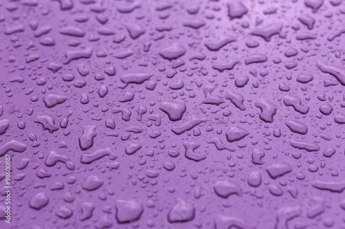 Drop water rain on the purple car in close up background and tex