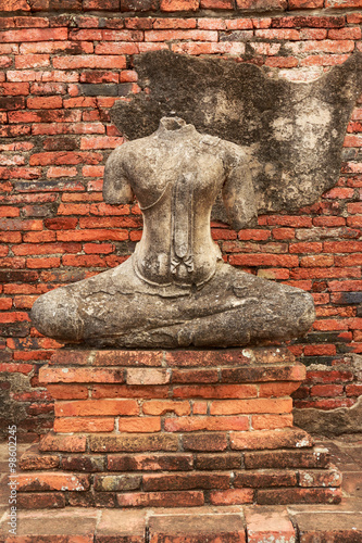 The broken Buddha statues on old brick wall in Wat Chaiwatthanar