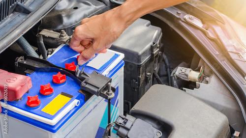 Open cap of battery for add distilled water by hand, maintenance