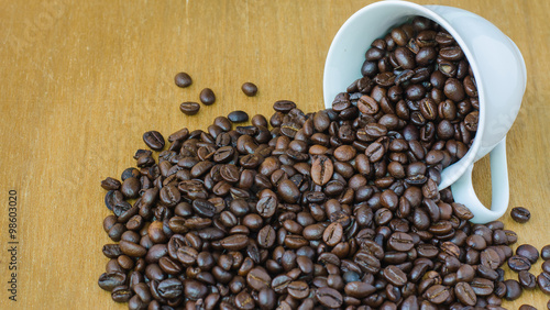 Coffee bean in cup on wooden  selective focus