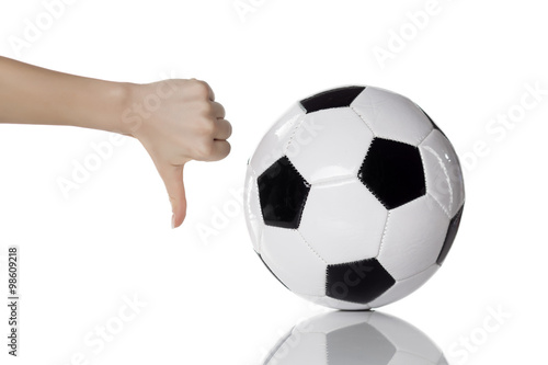 soccer ball and female hand with thumb down