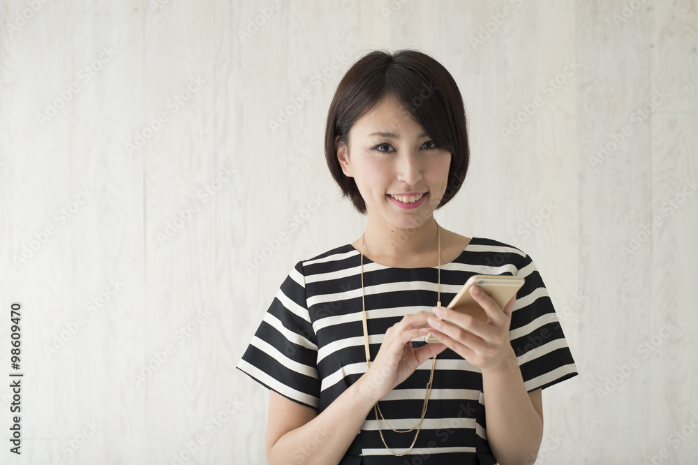 Beautiful Japanese woman is smiling with a smartphone