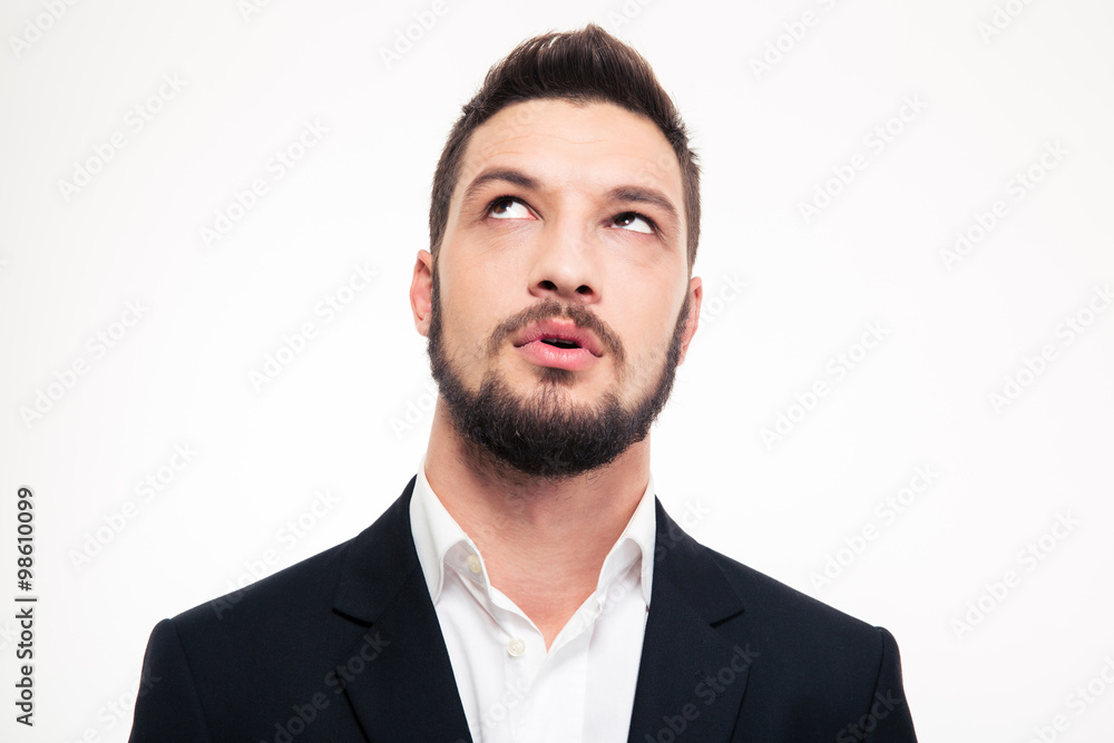 Portrait of pensive attractive young man thinking and looking up Portrait of pensive attractive young man thinking and looking up