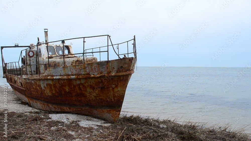 Rusty fishing ship ashore.