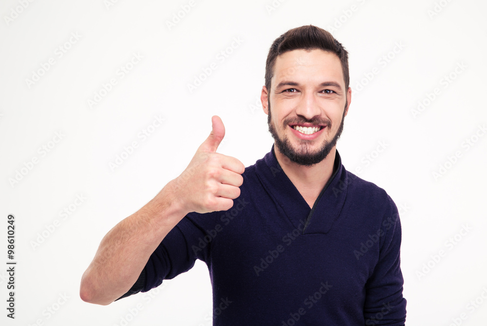 Cheerful attractive bearded man smiling and showing thumbs up Cheerful attractive bearded man smiling and showing thumbs up