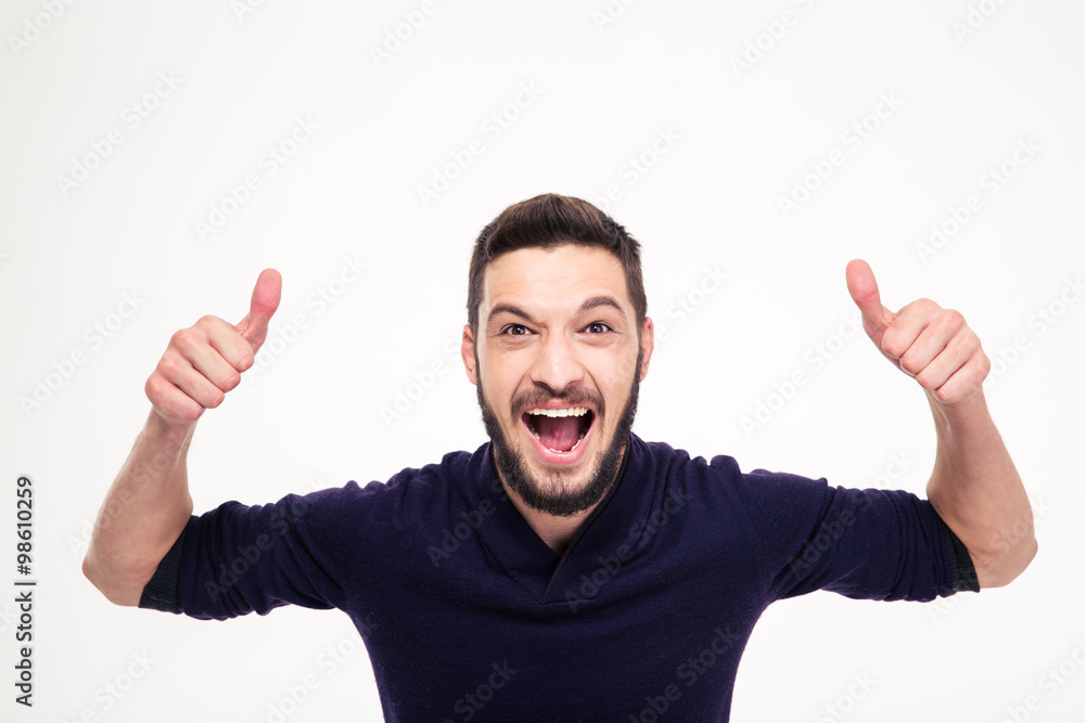 Elated excited young happy man shouting and showing thumbs up Elated excited young happy man shouting and showing thumbs up