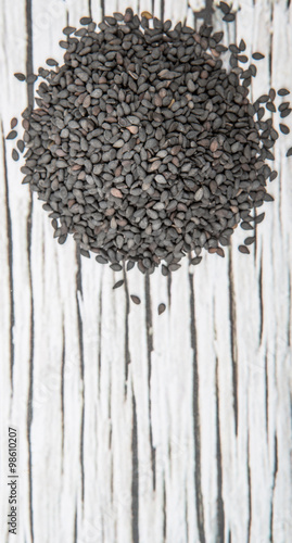 Black sesame seed over wooden background