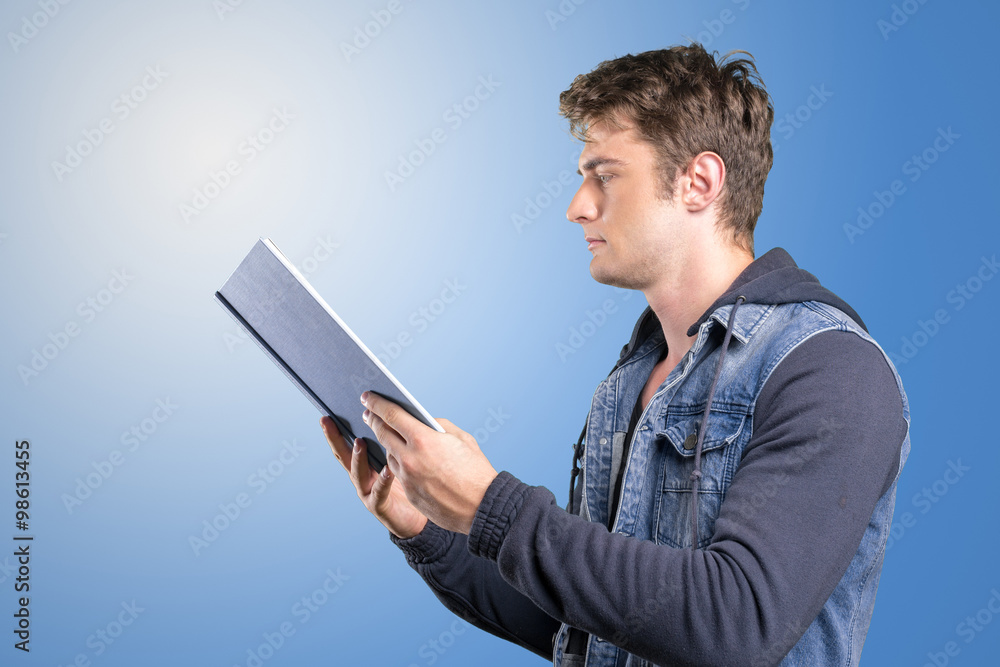 Young man, student reading a book Young man, student reading a book