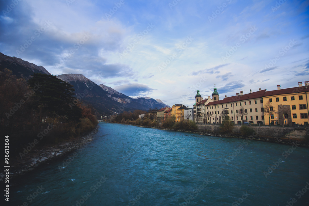 Beautiful super wide-angle aerial view of Innsbruck, Austria with skyline, Alps mountains and scenery beyond the city, and Inn river 