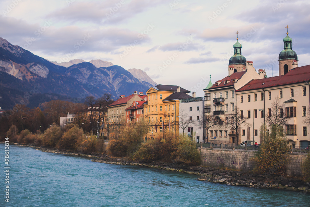 Fototapeta premium Beautiful super wide-angle aerial view of Innsbruck, Austria with skyline, Alps mountains and scenery beyond the city, and Inn river 