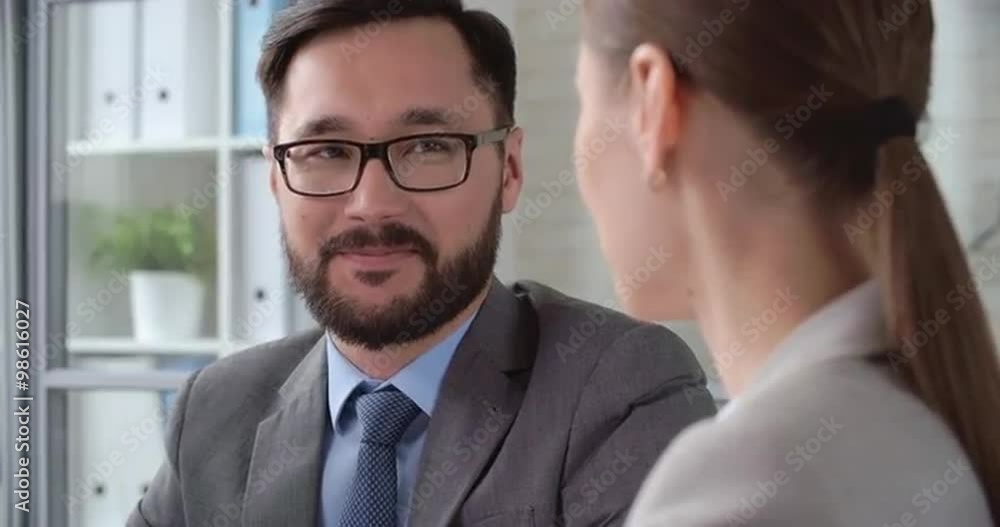 Asian businessman negotiating with his female colleagues Asian businessman negotiating with his female colleagues
