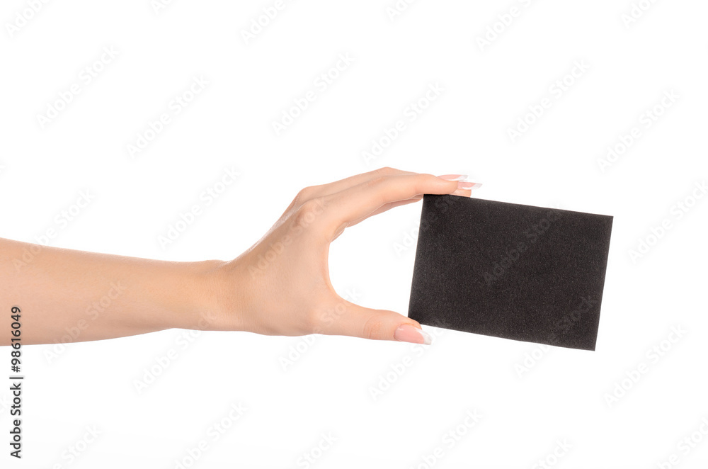 Branding and advertising theme: beautiful female hand holding empty black paper card isolated on white background Branding and advertising theme: beautiful female hand holding empty black paper card isolated on white background