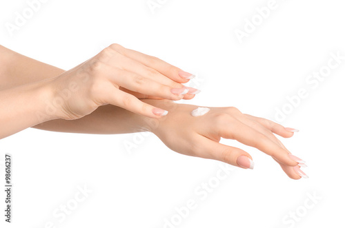 Health and body care theme  beautiful female hand with white cream isolated on a white background  hand massage