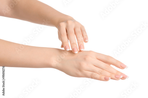 Health and body care theme: beautiful female hand with white cream isolated on a white background, hand massage © Parad St