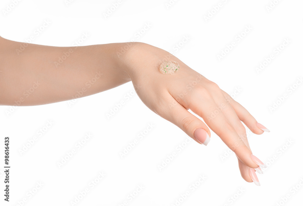 Health and body care theme: beautiful female hand with a transparent scrub cream on a white background isolated