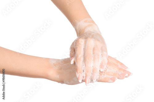 Hygiene and health protection topic: a woman's hand in soapsuds isolated on white background in studio