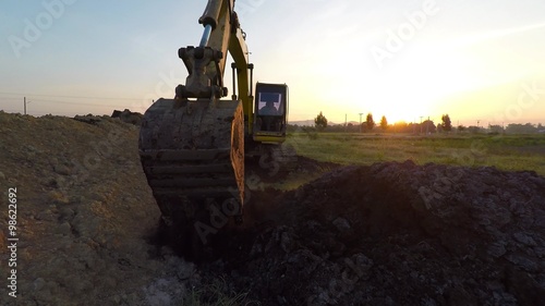 Excavator at sunset 3 photo