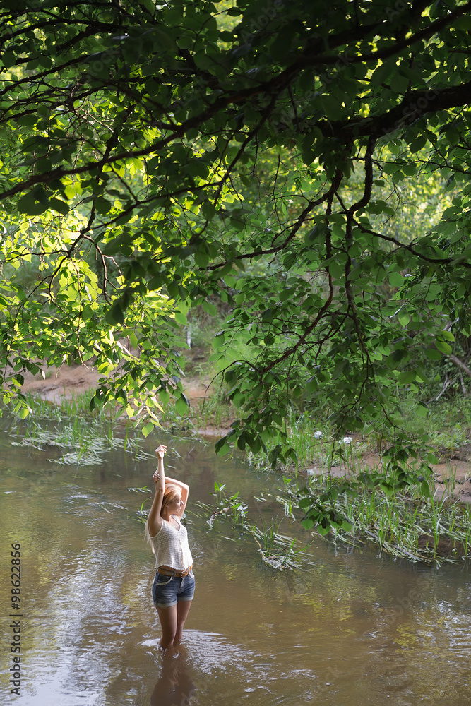 Fototapeta premium girl standing in the river