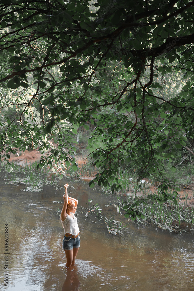 Fototapeta premium girl standing in the river