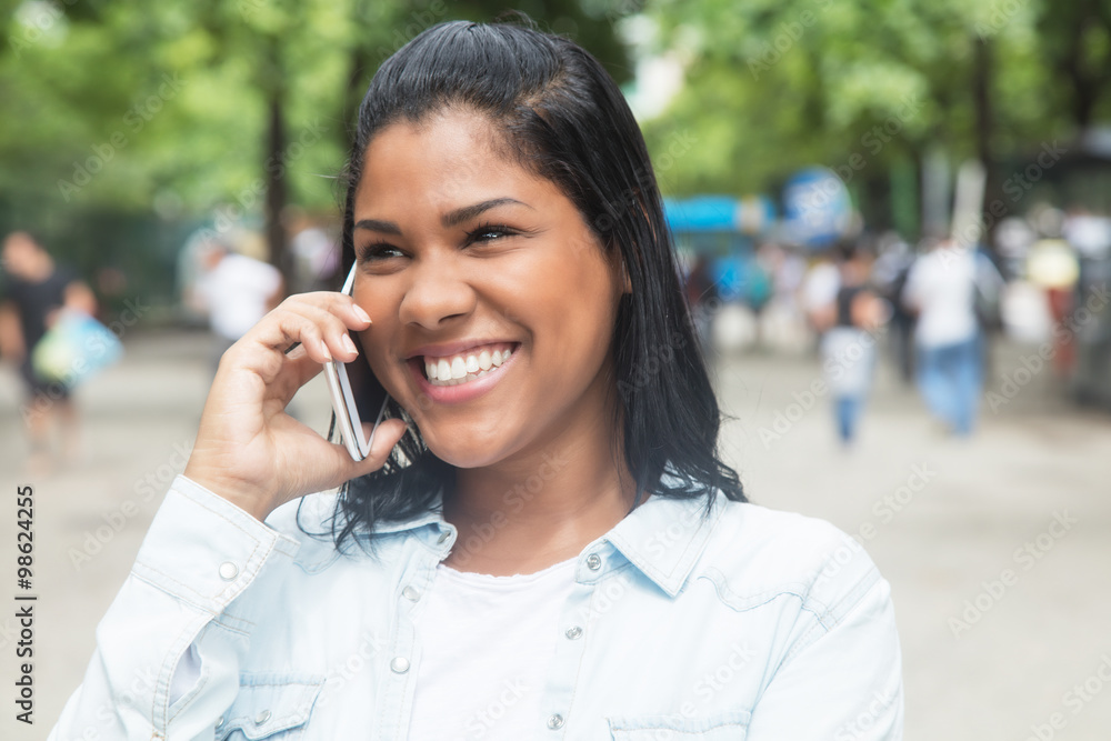 Junger Mexikanerin in der Stadt mit Handy Junger Mexikanerin in der Stadt mit Handy