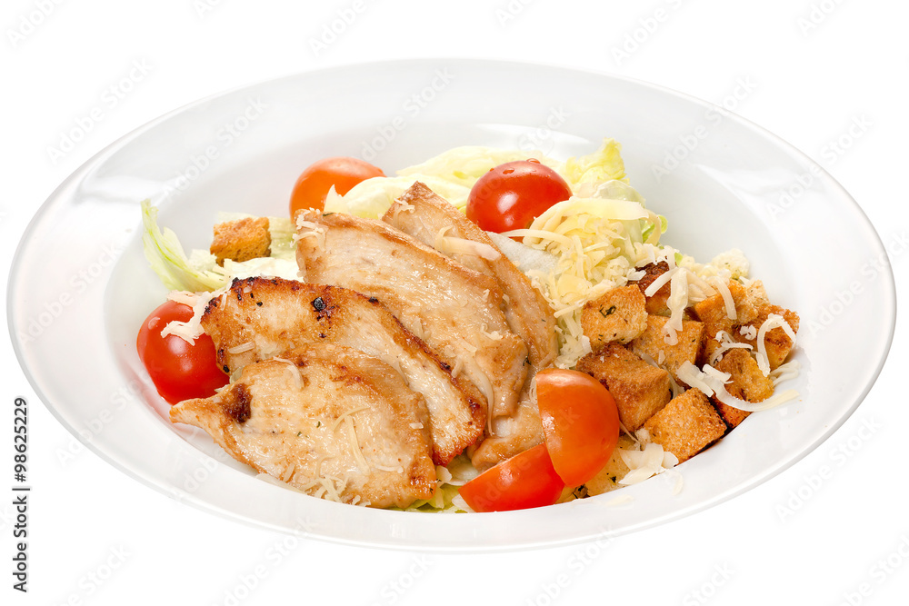 Caesar salad. Chicken meat slices, cheese and vegetables: cherry tomatoes, cabbage, croutons on a white plate on a white background Caesar salad. Chicken meat slices, cheese and vegetables: cherry tomatoes, cabbage, croutons on a white plate on a white background