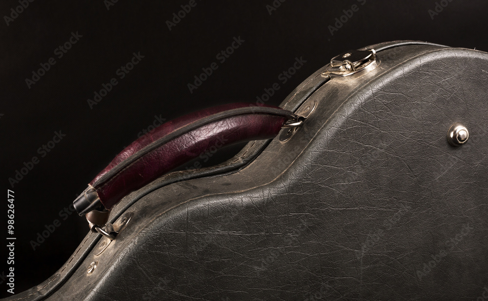 Fototapeta premium Grey leather case for mandolin on black background.