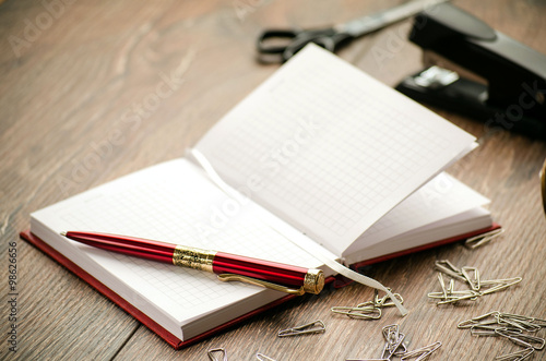 Wallpaper Mural Notepad, pen, staples, stapler and scissors on the table Torontodigital.ca