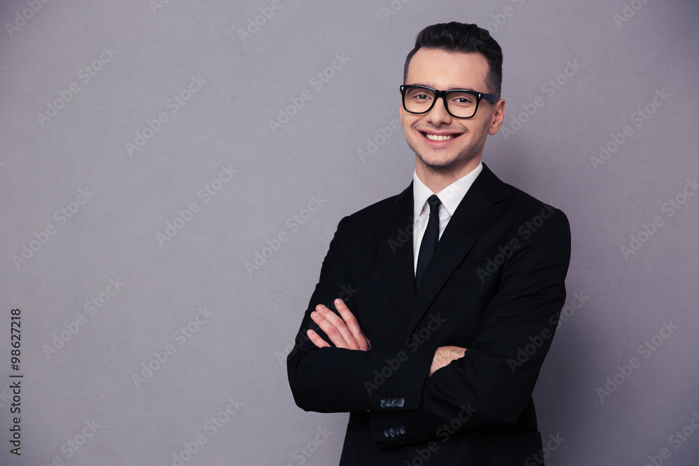 Happy businessman in glasses standing with arms folded Happy businessman in glasses standing with arms folded
