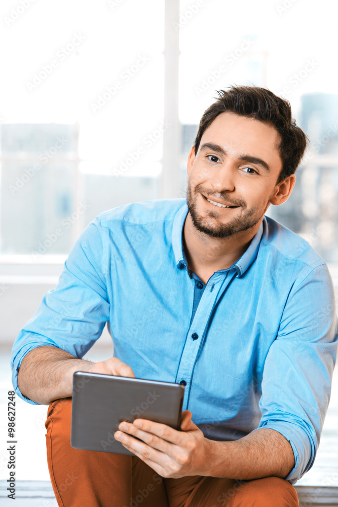 Young businessman in office with window