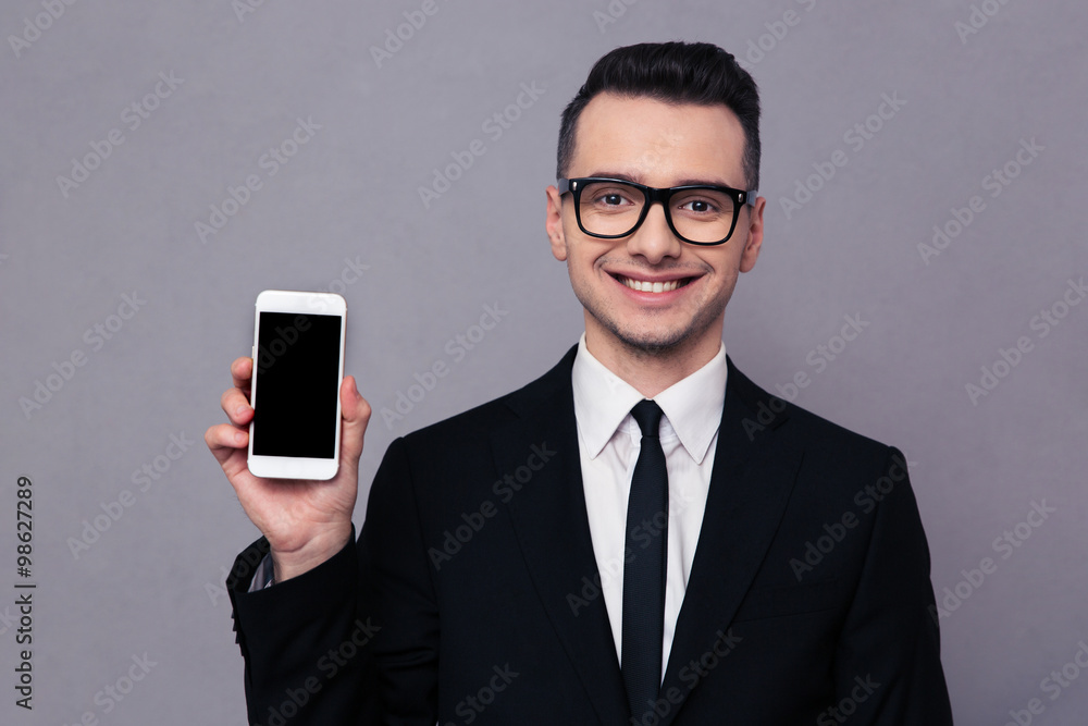 Smiling businessman shoing blank smartphone screen Smiling businessman shoing blank smartphone screen