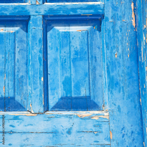 greece home texture of a blue antique wooden old door in santori © lkpro