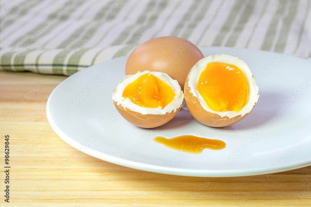 half medium-boiled eggs on white dish half medium-boiled eggs on white dish