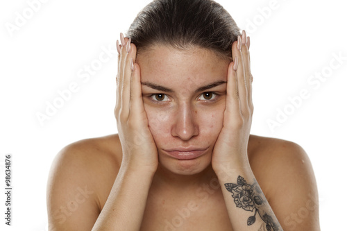 unhappy and lonely young woman on a white background