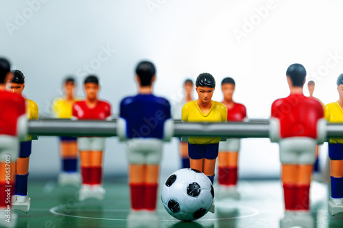 Table football game with yellow and red players