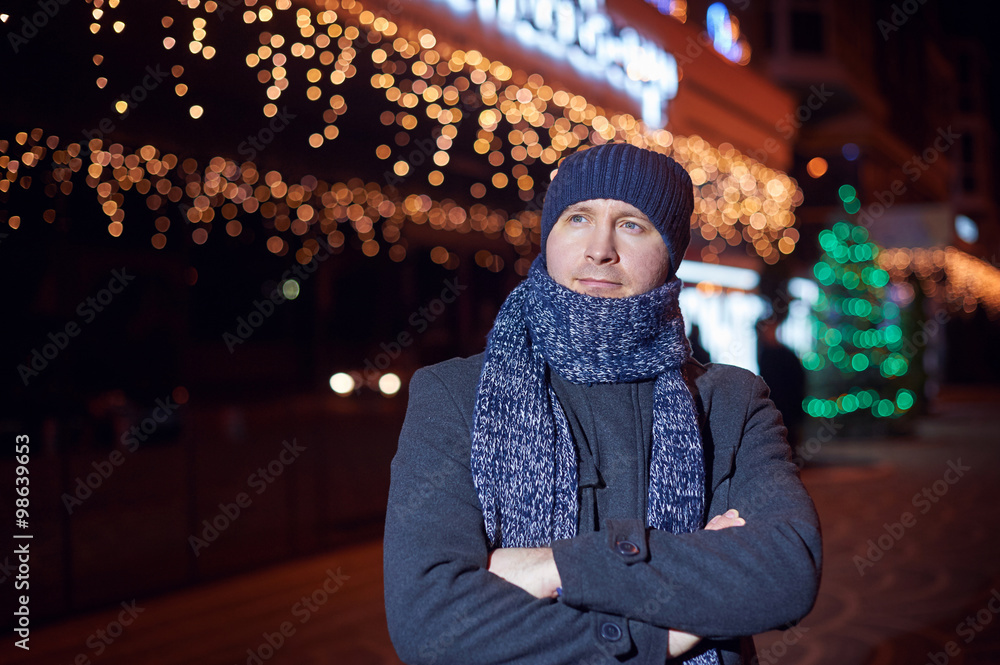 Portrait of elegant fashionable man dressed in coat and scarf