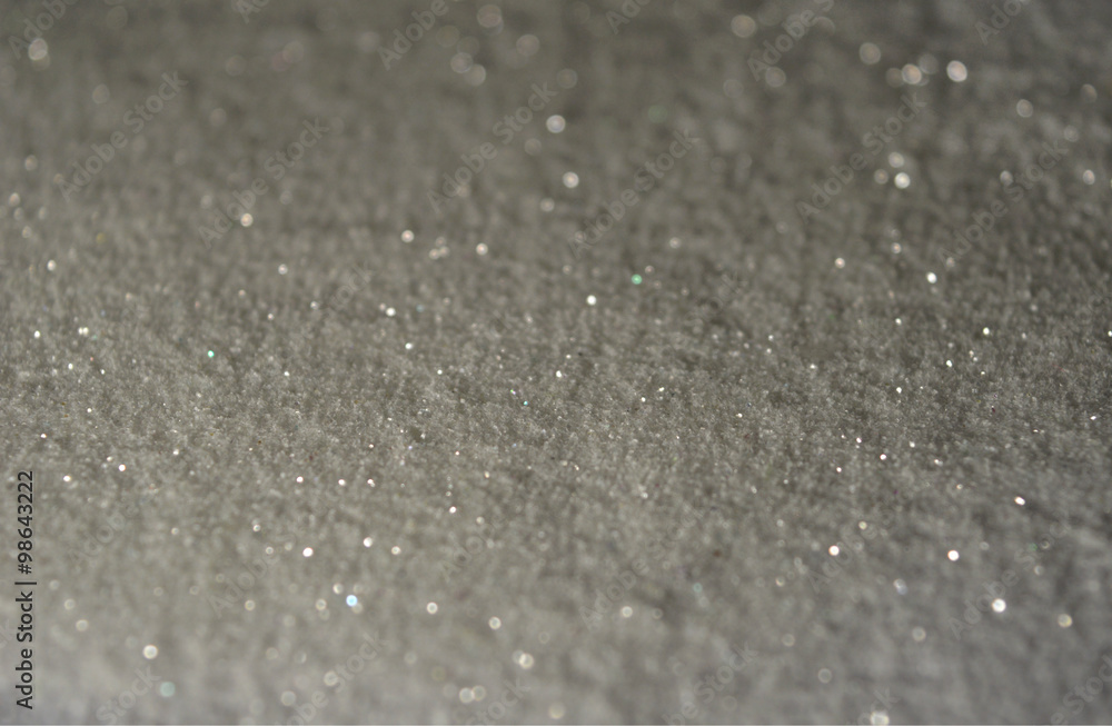 Blurred background with glitter sparkles like a snow in the night lights