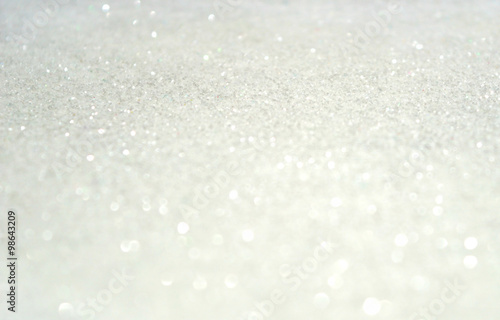 Blurred holiday background with white glitter sparkles like a snow