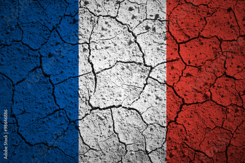 Aged old textured France flag. Grunge cracked soil effect used.