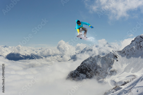 Flying snowboarder on mountains