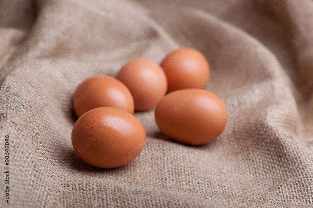 Fresh eggs scattered on sacking Fresh eggs scattered on sacking