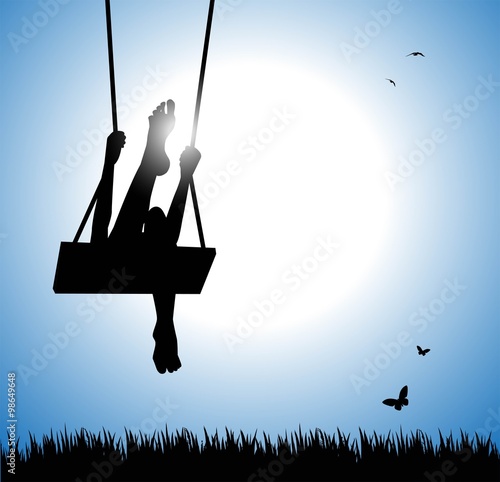 silhouette of happy young woman on a swing