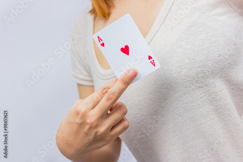 young woman holding in hand poker card with combination of Full