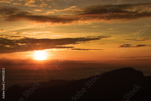 Beautiful sunset at the mountains. Colorful landscape with sun and
