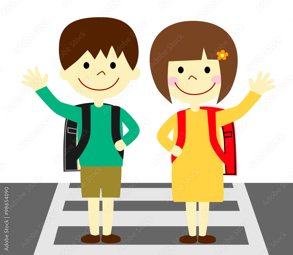 横断歩道で手を上げる子供たち