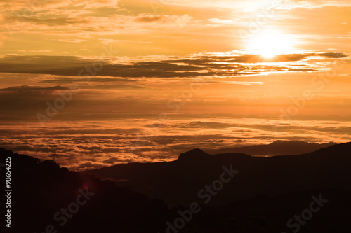 Beautiful sunset at the mountains. Colorful landscape with sun and