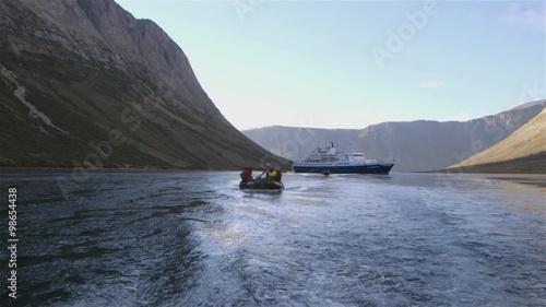 Tourists on a zodiac boat tour through Torngat Mountains during an expedition. Slow Motion photo